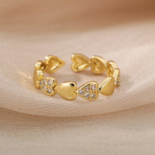 Anillo ajustable de acero inoxidable dorado con corazones y circonitas
